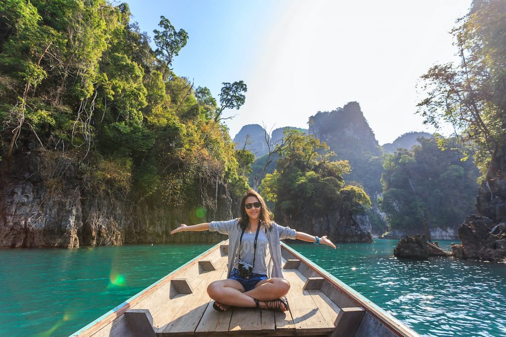The Pros and Cons of the freedom where you work - photo of woman sitting on boat spreading her arms