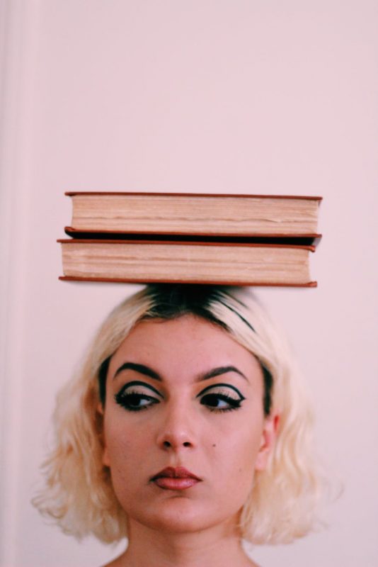 two book on woman head