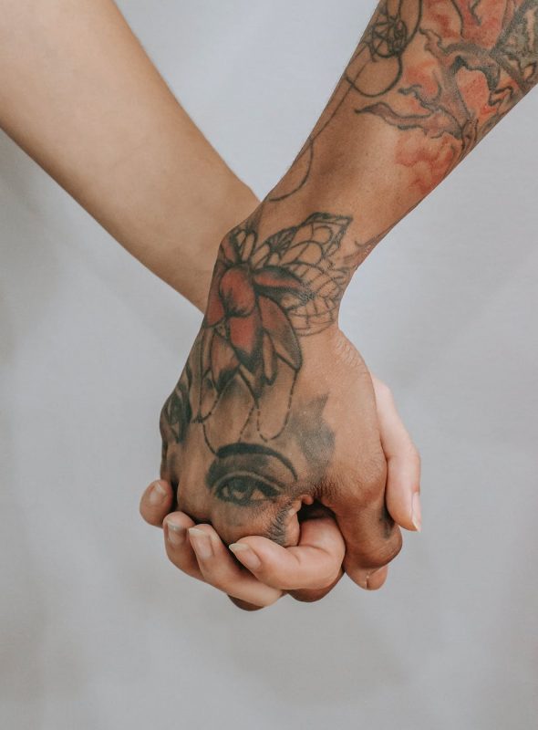 people holding hands together closely
