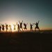 Silhouette Photography of Group of People Jumping during Golden Time